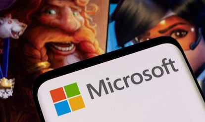 Microsoft logo is seen on a smartphone placed on displayed Activision Blizzard's games characters in this illustration taken January 18, 2022.