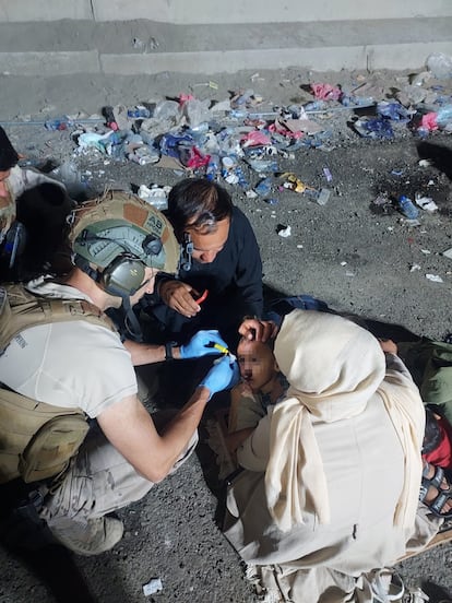 A Spanish doctor treating a child who was injured while entering the base. 