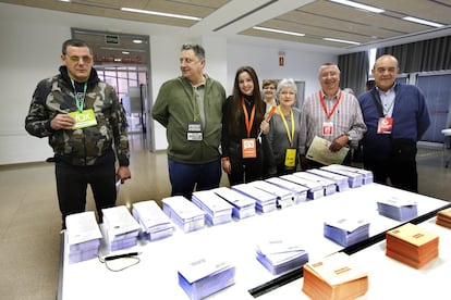 Apoderados de varios partidos políticos posan ante una mesa electoral en el Centro Cívico Montserrat Roig de Terrassa.