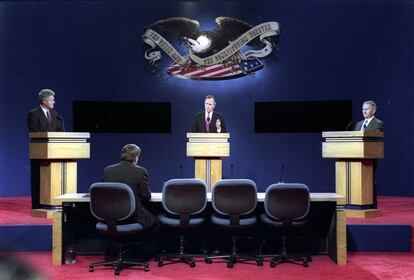 George Bush consume un turno de palabra durante el tercer debate electoral de las presidenciales de 1992 mientras Clinton y Perot le escuchan.