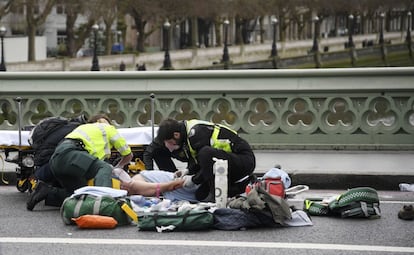 Médicos tratan a una persona herida después del atentado en el puente de Westminster en Londres.