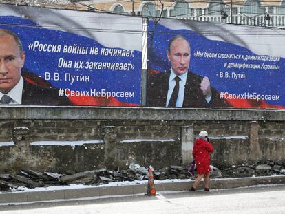 Signs with the face of Vladimir Putin in Simferopol, Crimea, on Friday. The text on the left says: "Russia does not start wars, it ends them."