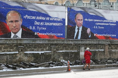 Signs with the face of Vladimir Putin in Simferopol, Crimea, on Friday. The text on the left says: "Russia does not start wars, it ends them."