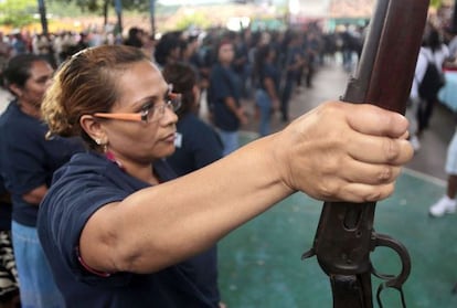 A woman holds a shotgun during the presentation of armed vigilante group - Citizens Self-Protection Police - in Acapulco, Guerrero state. 