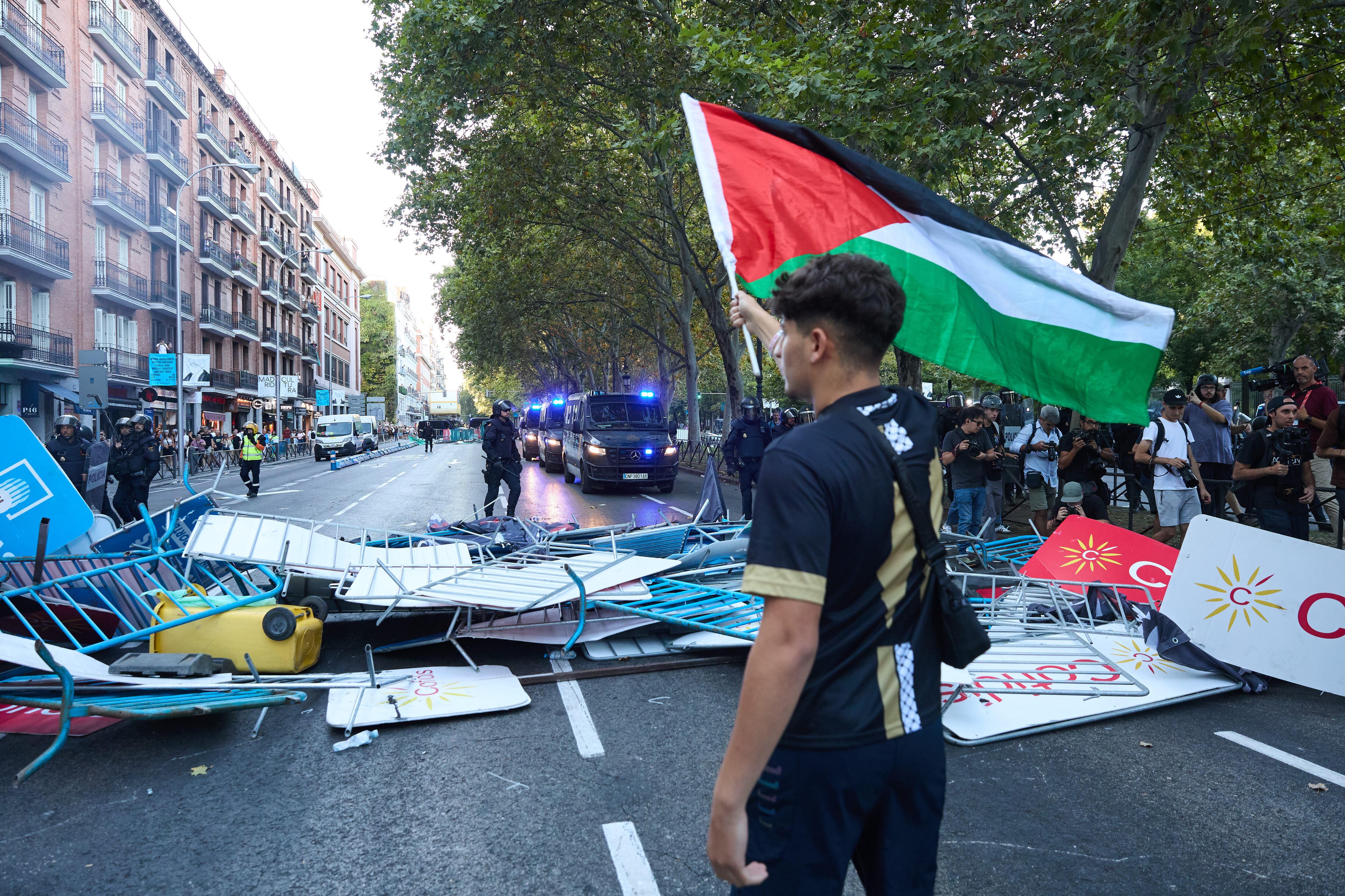 Un joven con una bandera de Palestina en Atocha, el día de la etapa 21 de la Vuelta Ciclista a España, el 14 de septiembre, en Madrid.