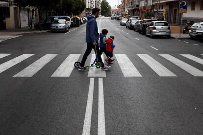 Two children cross a road in Madrid on Sunday.