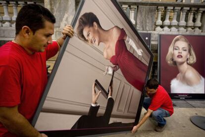 Unos operarios colocan las fotografías de una exposición paralela al Festival de San Sebastián en la plaza de Oquendo.
álvaro barrientos (ap)