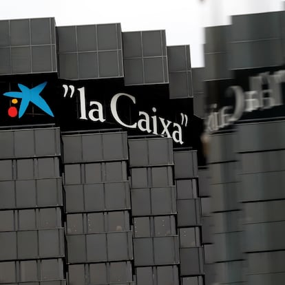 LaCaixa's logo is reflected in a glass at the company's headquarters in Barcelona, Spain, September 17, 2020. REUTERS/Albert Gea