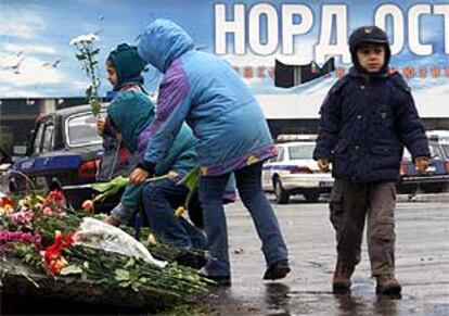 Varios niños colocan flores en la puerta del teatro Dudrovka de Moscú, donde los secuestradores chechenos retuvieron a 800 rehenes.