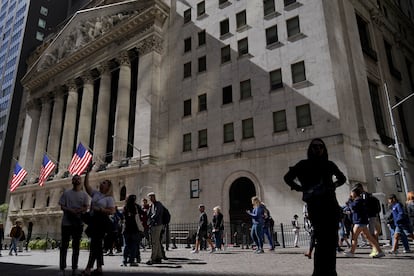 Visitors to the financial district walk past the New York Stock Exchange, Friday, Sept. 23, 2022, in New York.