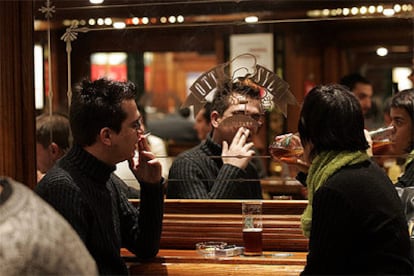 Un jóven fuma en un local de comida rápida en la Gran Via de Barcelona.