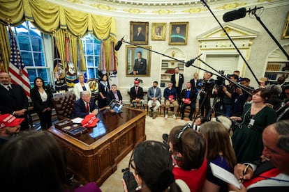 Donald Trump answers questions from reporters after signing executive orders in the Oval Office on April 23.