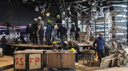 Construction crews prepare one of the theater stages on the new ship.