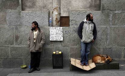 Two homeless men on the street in Madrid.