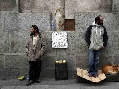 Two homeless men on the street in Madrid.