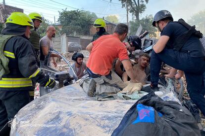 Ukrainian emergency teams remove a man injured by a Russian attack from a car in Dnipro, central Ukraine, on June 28.