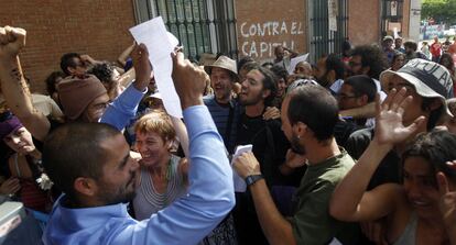 Uno de los indignados que sortearon el cordón policial con camisa y pantalón de pinzas celebra con sus compañeros la entrega del documento del 15-M en el Congreso.