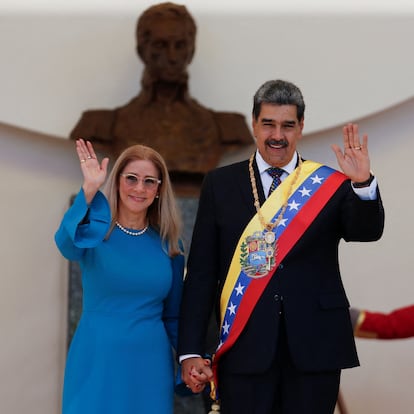 President Nicolas Maduro and his wife Cilia Flores wave on the day of his inauguration for a third six-year term in Caracas, Venezuela January 10, 2025. REUTERS/Leonardo Fernandez Viloria