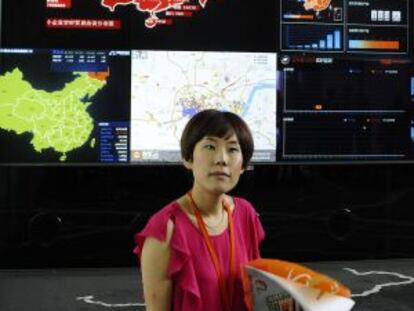 Uma empregada de Alibaba junto à tela que controla as transações