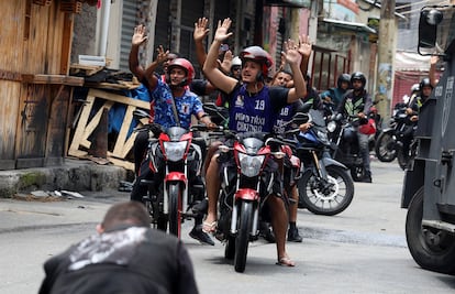 People react on motorcycles during a police operation against drug trafficking at the favela do Penha, in Rio de Janeiro, Brazil October 28, 2025