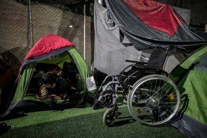 Un refugiado descansa junto a su silla de ruedas.