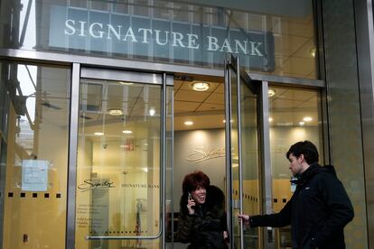 A woman leaves a branch of Signature Bank in New York, Monday, March 13, 2023.