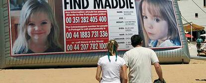 Los padres de Madeleine, desaparecida en el sur de Portugal el pasado 3 de mayo, pasan por delante de un cartel hinchable gigante con datos de su hija en Praia da Luz.