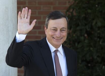 Mario Draghi waves before a meeting at La Moncloa prime ministerial palace in Madrid.