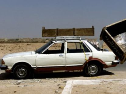 Un hombre transporta un ataúd tras el funeral de una madre y de una hija muertas en un atentado con coche-bomba en Irak en 2003