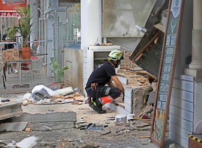 A firefighter looks inside the damaged building in Palma on May 24. 