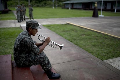 Soldier Denis Muriel, 20, practices with a trumpet at a military base in Madre de Dios, Peru, Tuesday, June 2, 2015. The Peruvian government launched an operation to detect by radar and intercept illegal flights carrying cocaine from the Peruvian jungle to Bolivia and Brazil. (AP Photo/Rodrigo Abd)