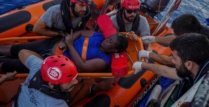 NBA Memphis player Marc Gasol and members of NGO Proactiva Open Arms rescue boat carry African migrant in central Mediterranean Sea