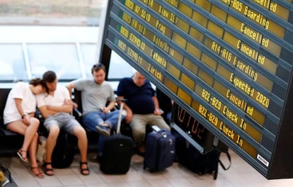 Pasajeros esperan junto a un panel con vuelos cancelados en Berlín.