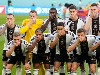 German's team covers their mouth during the team photo prior to the World Cup group E soccer match between Germany and Japan, at the Khalifa International Stadium in Doha, Qatar, Wednesday, Nov. 23, 2022. (AP Photo/Matthias Schrader)