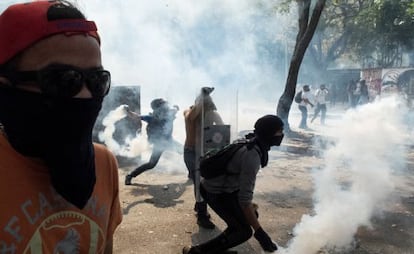 Demonstrators throw tear gas canisters back at security forces on Wednesday in Caracas.