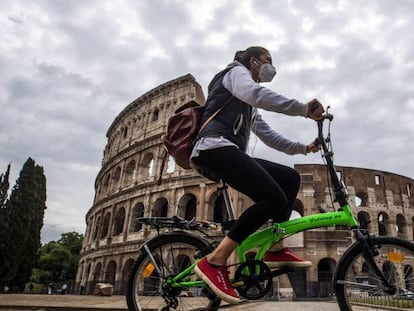  Una ciclista pasa frente al Coliseo romano. 