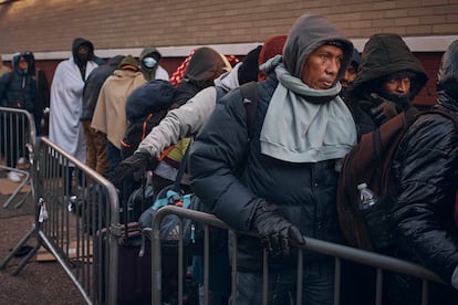 Migrants line up outside a shelter in New York, November 2023.