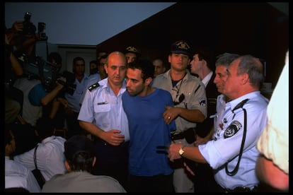Yitzhak Rabin's assassin, Yigal Amir, is escorted to the court in Tel Aviv in 1995.