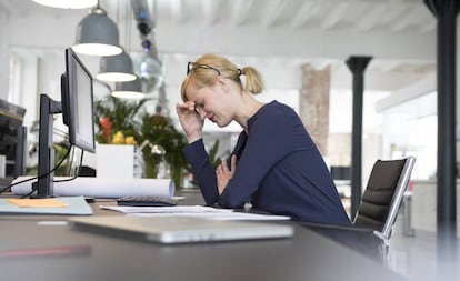 Una mujer estresada en el trabajo. 