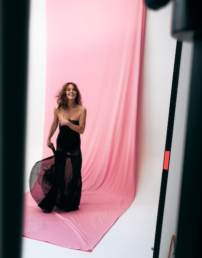 "I'm not worried about aging. I inherited my father's genes. He's 92 years old and he was skydiving until not long ago," says Philippine Leroy-Beaulieu. In this photo, the actress wears a Cortana silk tulle dress and roulotte and Saint Laurent x Anthony Vaccarello sandals and a red ring. 