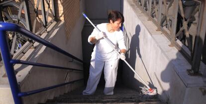 Una limpiadora pasa la fregona en la escalera de un Parking en Jerez (Cádiz)
