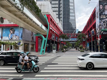 People ride a scooter on a street in Taipei, Taiwan August 10, 2022. REUTERS/Aleksander Solum