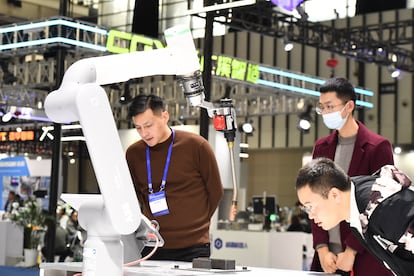 Visitors tour the industrial robot exhibition area at the 2023 World Intelligent Manufacturing Conference in Nanjing, China, on December 6, 2023.