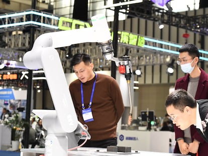 Visitors tour the industrial robot exhibition area at the 2023 World Intelligent Manufacturing Conference in Nanjing, China, on December 6, 2023.