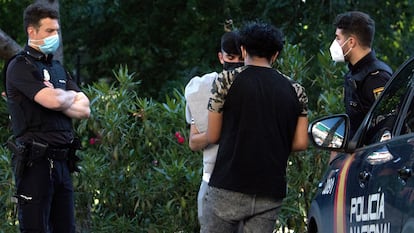 Dos policías identifican a unos jóvenes en el parque de la Amistad, en Villaverde, el martes.