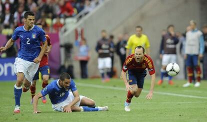 Andrés Iniesta (right) feels the force of a tackle by Italy defender Leonardo Bonucci in Gdansk.