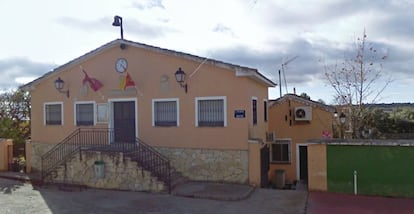 Fachada del ayuntamiento de Esplegares con la entrada al único bar del pueblo al fondo.