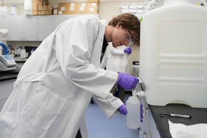 Logan Feeney pours a PFAS water sample