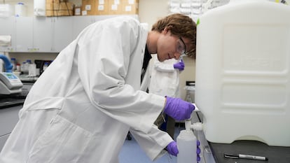 Logan Feeney pours a PFAS water sample into a container for research, April 10, 2024, at a U.S. Environmental Protection Agency lab in Cincinnati.