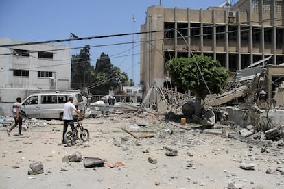 Varios palestinos se acercan a la sede de la UNRWA en Gaza para buscar víctimas entre los escombros del edificio bombardeado, el pasado junio.